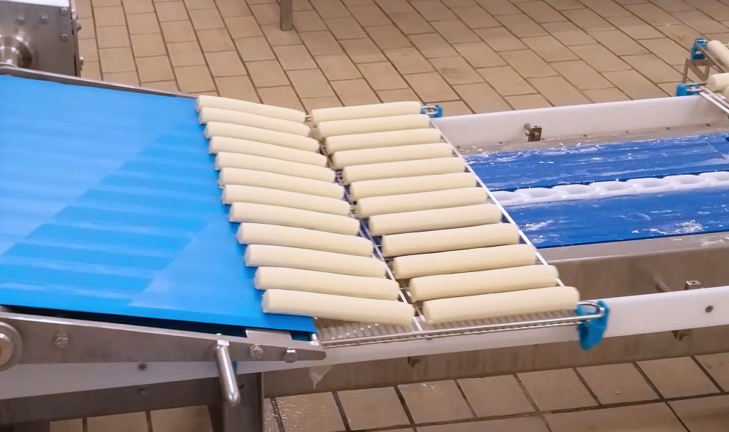 Mise en claies de bûches de fromage